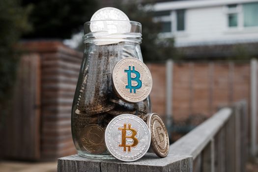 Digital currency physical gold and silver bitcoin coin in garden.