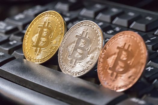 Cryptocurrency coins over black keyboard; Bitcoin  coins