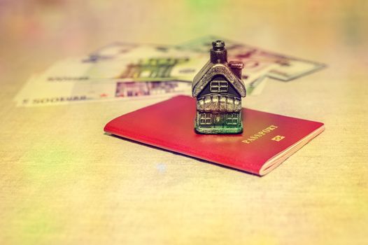 Passport, money and home - the concept of buying a property.