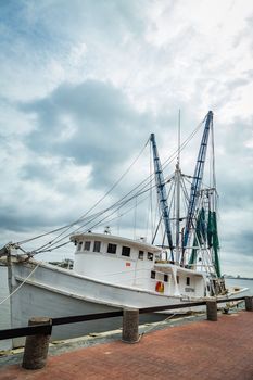 SAVANNAH, GEORGIA - MARCH 1, 2018: A shrimp boat is tied up on the River Street dock on the Savannah River.
