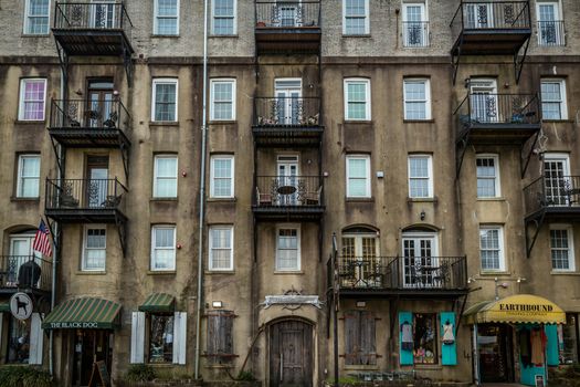 SAVANNAH, GEORGIA - MARCH 1, 2018: Historic cotton warehouses on River Street that have been converted into shops, apartments, and offices.