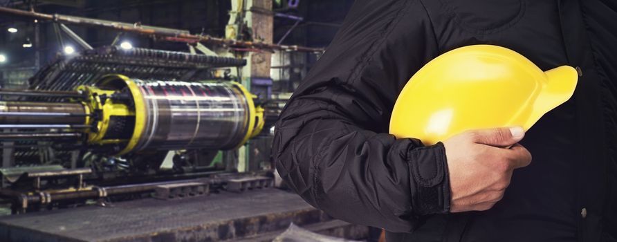 Worker with safety helmet at industrial factory