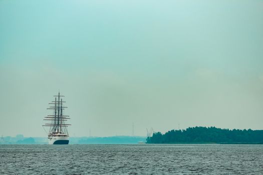 Big white sailing ship with three mast moving to the Riga port