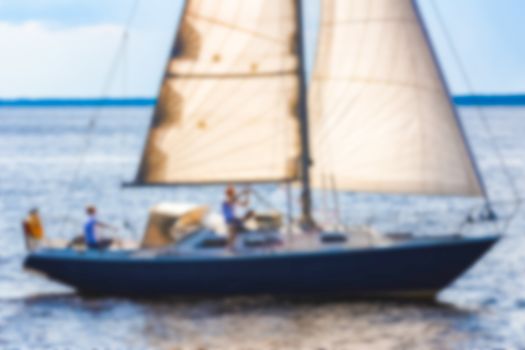 Blue sailboat - soft lens bokeh image. Defocused background