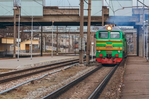 Green diesel cargo locomotive. Freight train in action