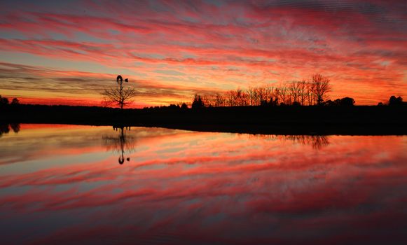 Sensational sunrise in rural Australia with reflections in farm dam