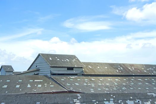 The roof of an old warehouse in the blue sky.