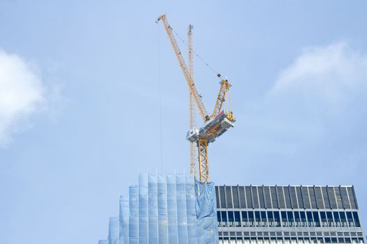 Condo building site with cranes and blue sky