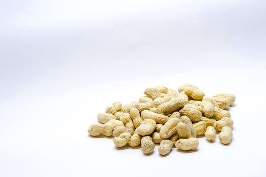 Many peanuts in the shell on a white background