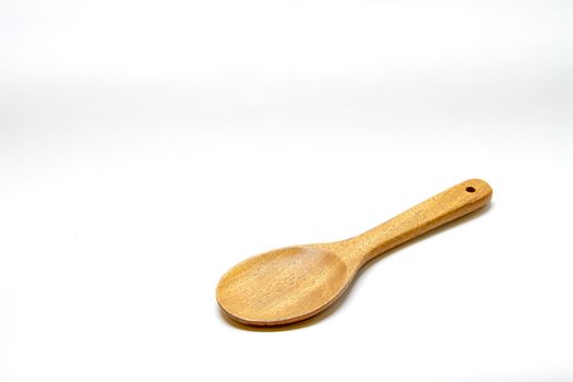 Brown wooden spoon on white background
