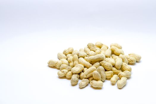 Many peanuts in the shell on a white background