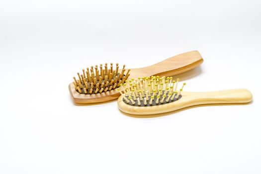 Hair brush comb with scraping hair on a white background.