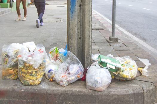 Pile of rubbish on the sidewalk, put a clear bag