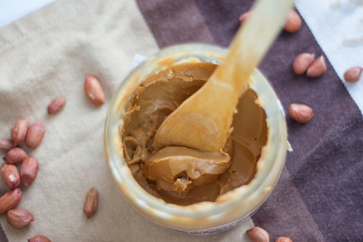 an open jar of peanut butter with spoon