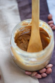 an open jar of peanut butter with spoon