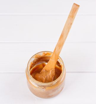 an open jar of peanut butter with spoon