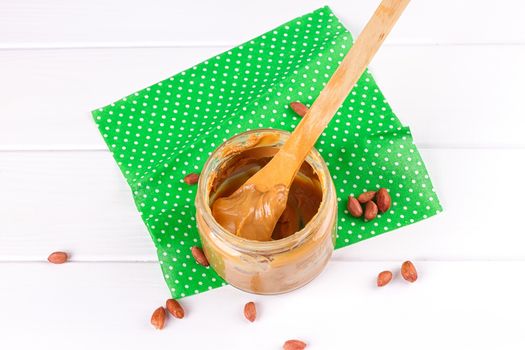an open jar of peanut butter with spoon