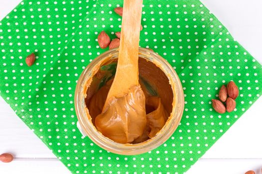 an open jar of peanut butter with spoon
