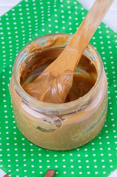 an open jar of peanut butter with spoon