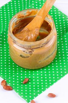 an open jar of peanut butter with spoon