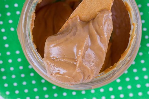 an open jar of peanut butter with spoon