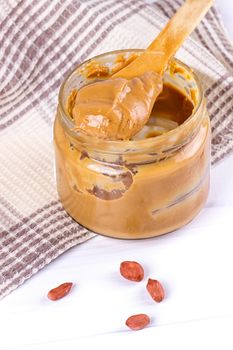 an open jar of peanut butter with spoon