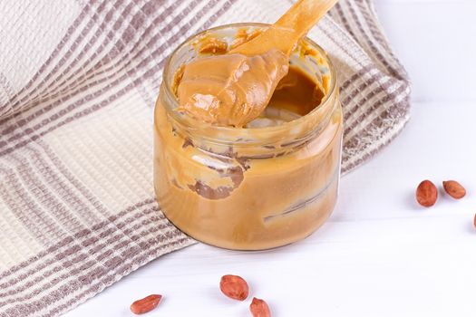 an open jar of peanut butter with spoon