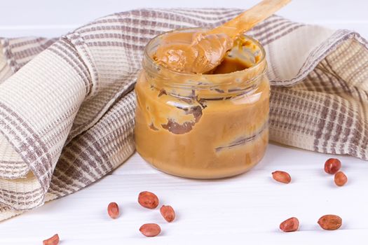 an open jar of peanut butter with spoon