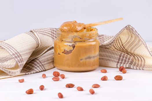 an open jar of peanut butter with spoon