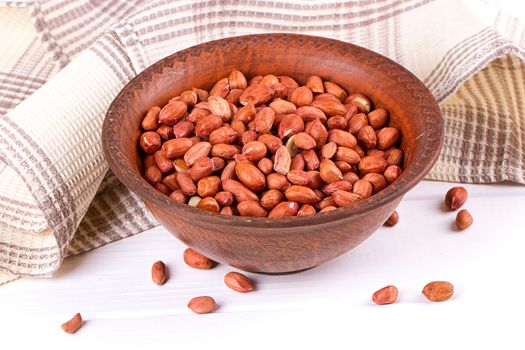 Peanuts in a brown plate. on white background