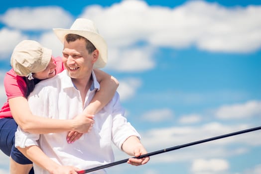 portrait of happy couple on fishing, woman hugging man