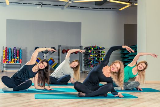 beautiful young girls are engaged in pilates in the gym, group classes