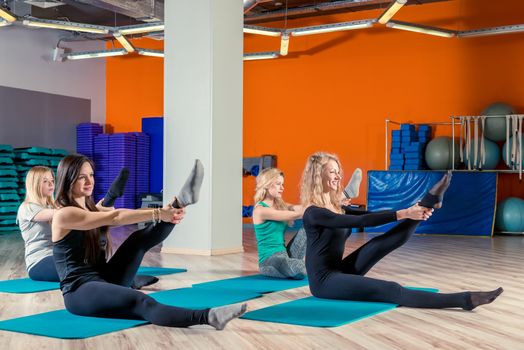 young women training in the gym, group classes in yoga