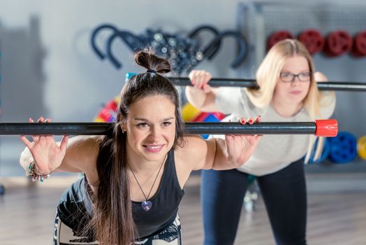 portrait of an active woman engaged with dumbbells in the gym in a group