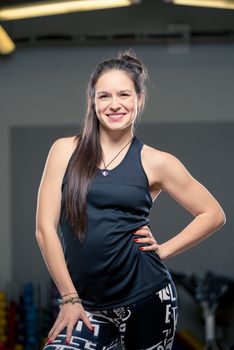 vertical portrait of young brunette in gym