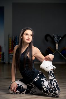 young woman in the gym on the floor doing stretching exercises