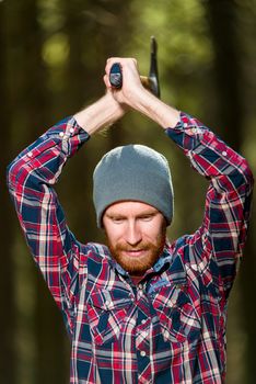 woodcutter while working with an ax, a vertical portrait in a forest