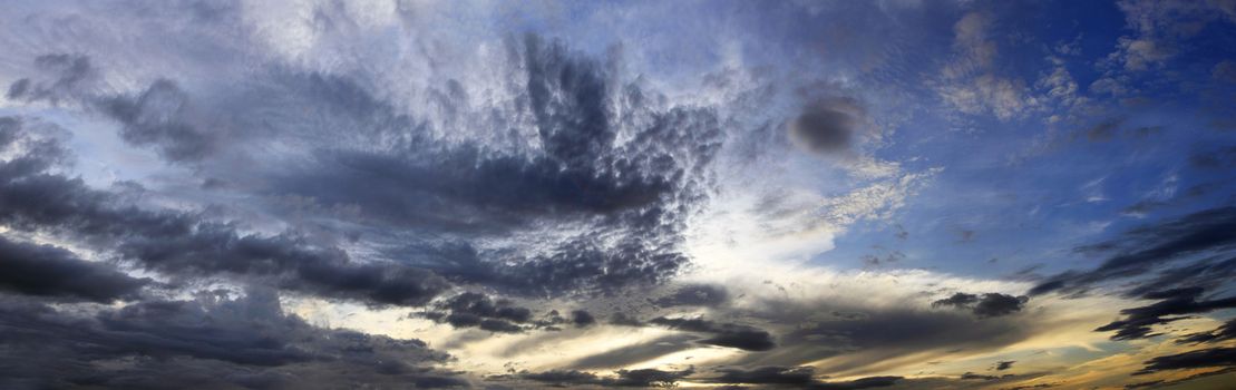 The image of clouds on a background of the dark blue sky