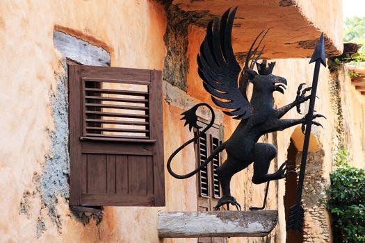 Metal mythical decoration on the facade of the building in Altos de Chavon. Dominican Republic