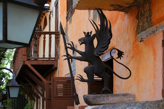 Metal mythical decoration on the facade of the building in Altos de Chavon. Dominican Republic