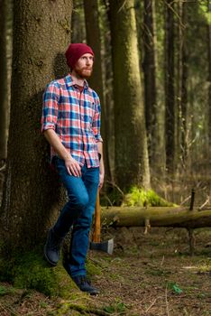 shooting a forester with an ax in the forest on a summer day