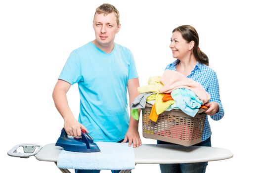 portrait of a happy married couple while ironing clothes isolated on white background