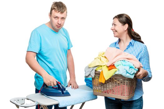 30 year old couple ironing things with iron, shooting in studio on white background