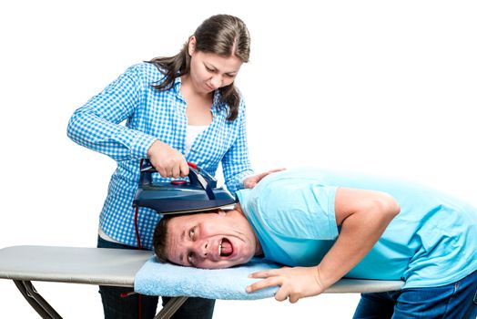 angry crazy wife stroking her husband's head with an iron, portrait isolated