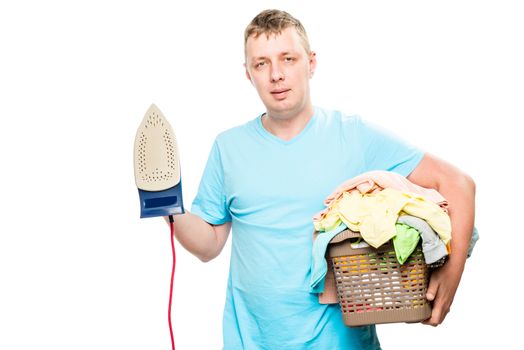 householder with iron and basket of clean linen on white background