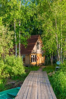 rural wooden fisherman's house on the shore of a lake and a wooden pier