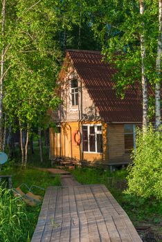 old wooden fisherman's house on the lake and a wooden pier