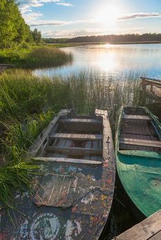 old boats in reeds on the lake in the morning