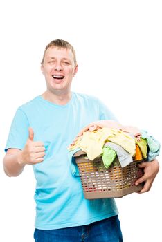 portrait of a happy man with a basket of clean laundry for ironing on a white background isolated