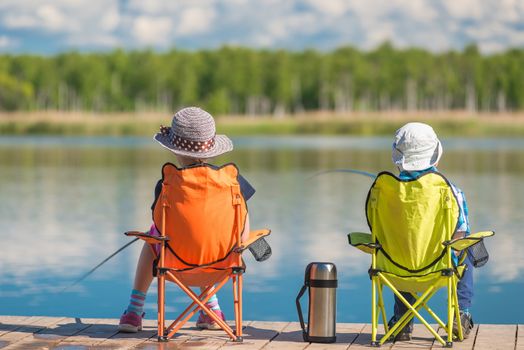 children spend a weekend fishing on the lake